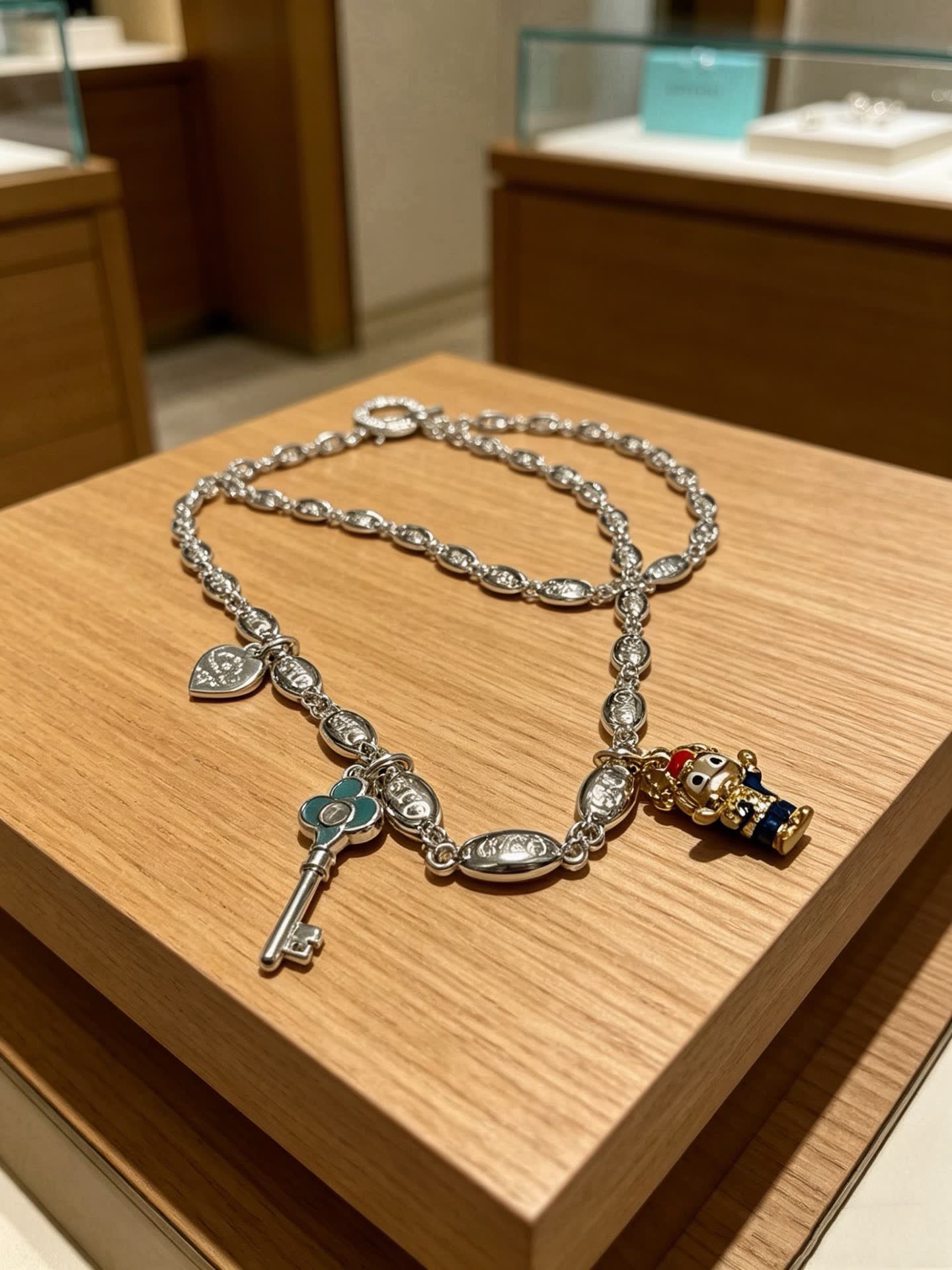 Tiffany & Co Silver Charm Bracelet with Key and Character Pendant Tiffany & Co Silver Charm Bracelet with Key and Character Pendant